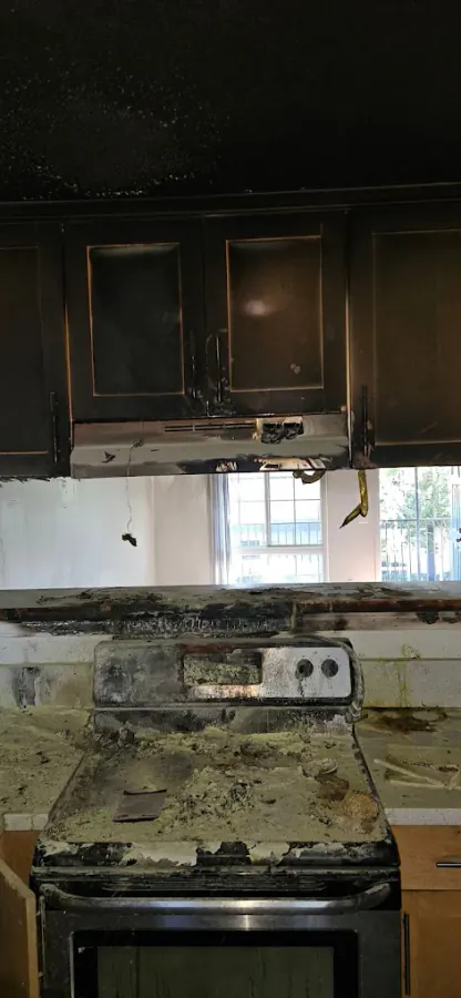 Kitchen fire damage showing charring and soot deposits