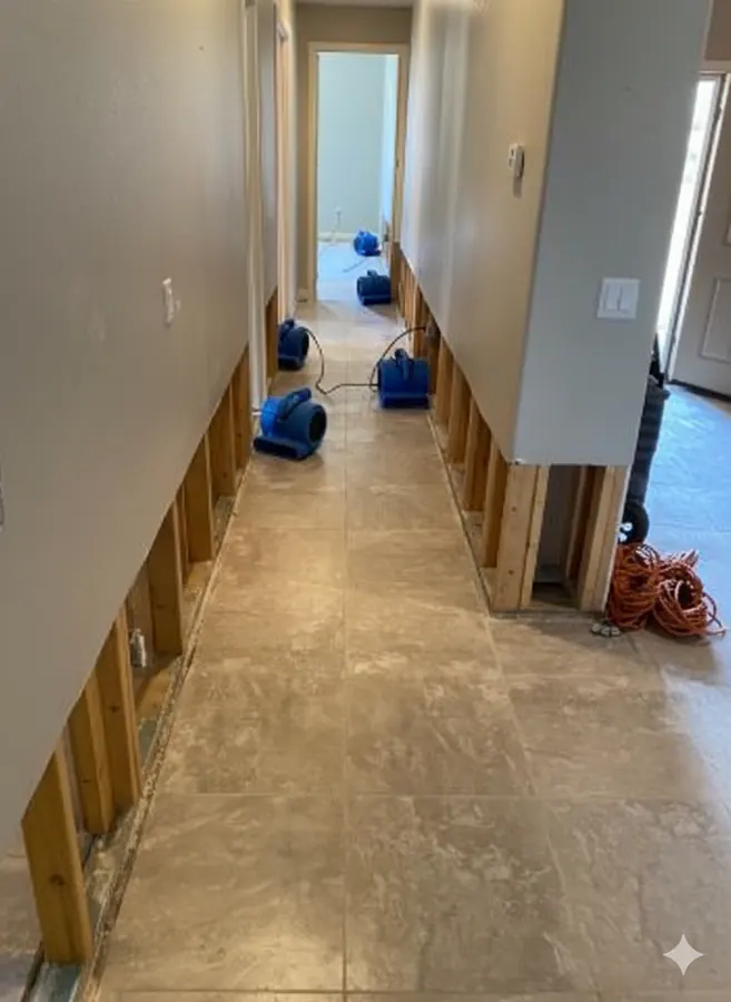 Air movers drying a hallway during residential water damage restoration in Murrieta